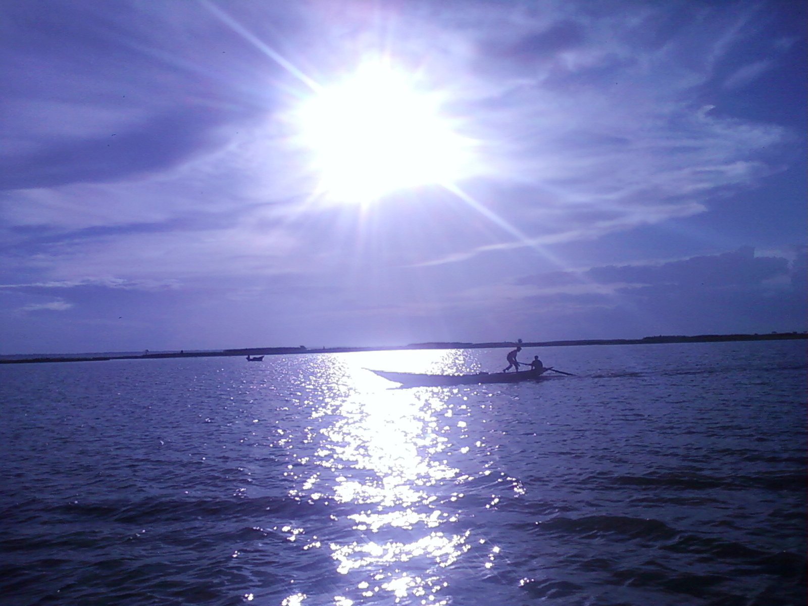 Sunset over the Padma river with boats